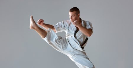 Man in white kimono training karate